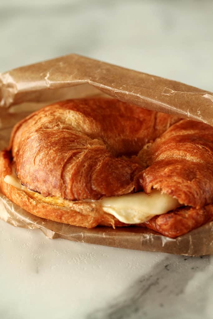 Ham, Egg and cheese in a croissant inside of a sandwich wrapper