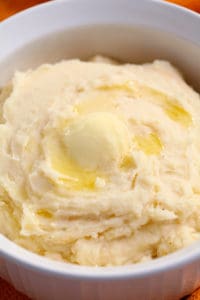 slow cooker mashed potatoes with butter melting on top