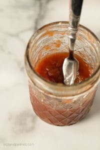 canning jar with slow cooker apple butter inside
