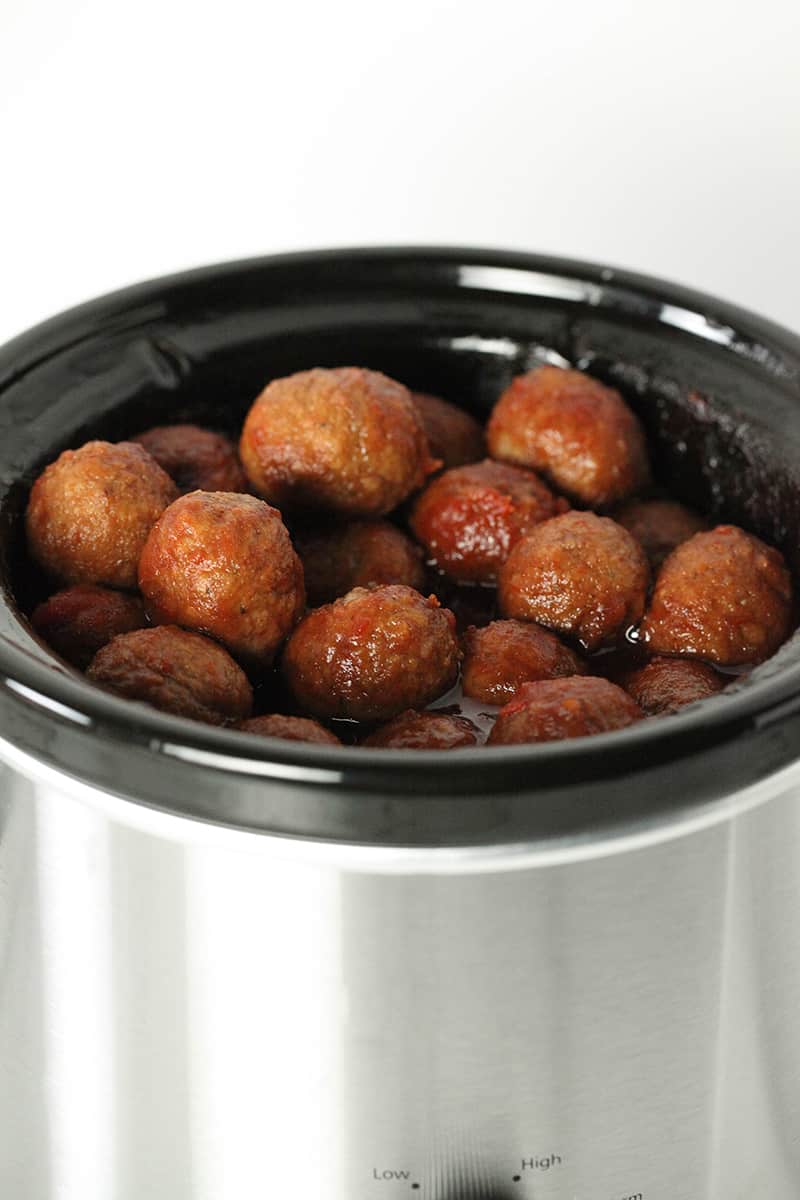slow cooker full of grape jelly chili sauce meatballs