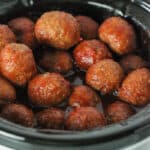 aerial view of slow cooker with grape jelly chili sauce meatballs