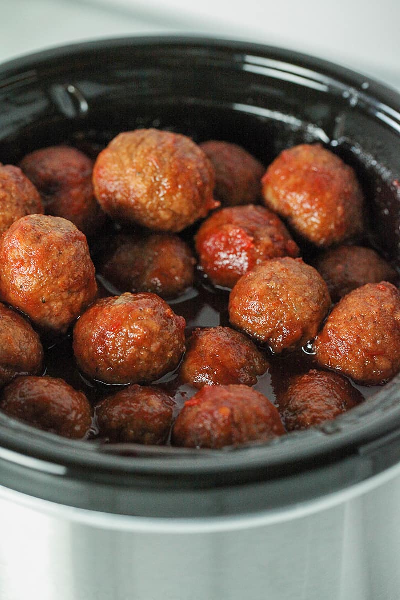 aerial view of slow cooker with grape jelly chili sauce meatballs